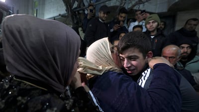 Palestinian detainee Khalil Zama hugs a relative after being released from an Israeli jail, at his home in Halhul in the occupied West Bank. AFP