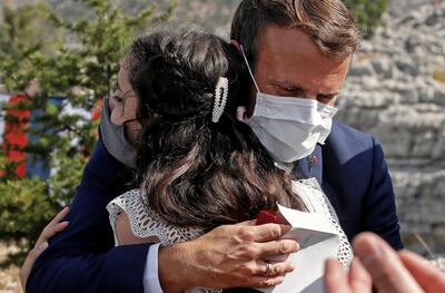 French President Emmanuel Macron consoles a victim of the August 4 Beirut blast during a visit to Lebanon on September 1, 2020. AFP