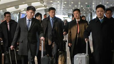 North Korean officials including a man believed to be Kim Hyok Chol, centre, wearing a blue tie, arrive in Beijing on February 19, 2019. AFP