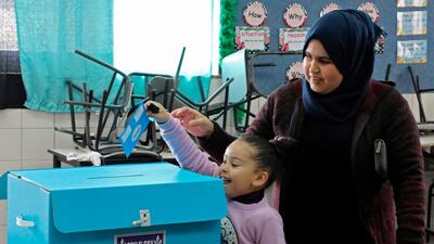 An Arab-Israeli girl casts her mother's ballot in the parliamentary election at a poling station in the Bedouin town of Rahat near the southern Israeli city of Beersheba on March 2, 2020. AFP