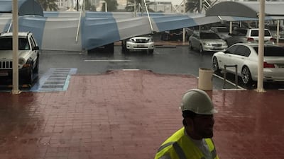 Car shades at Abu Dhabi Media blown down by heavy winds and rains. Mohammed Al Otaiba / The National