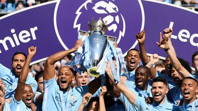 Vincent Kompany of Manchester City lifts the Premier League Trophy as Manchester City celebrate winning the Premier League after the Premier League match between Manchester City and Huddersfield Town at Etihad Stadium in Manchester, England, on May 6, 2018. Shaun Botterill / Getty Images
