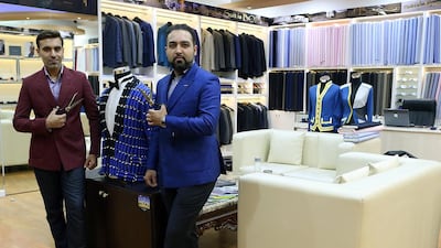 Knights & Lords owners Pawan Ishwar, left, Ashish Ishwar get about three to four new commissions in a day, resulting in around 45 new bespoke suits being made a month. Satish Kumar / The National