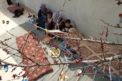 A family in a courtyard in the Syrian village of Jussiyeh, March 6, 2012, just across from Lebanon's eastern Bekaa region. AFP