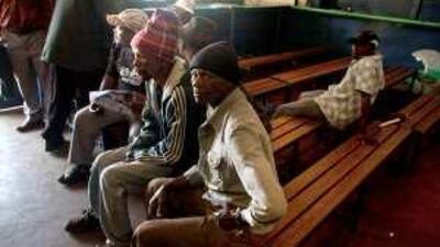 Miners wait to get debit cards at Teba Bank, owned by the union, as they wait for the mine owners to pay missing salaries.