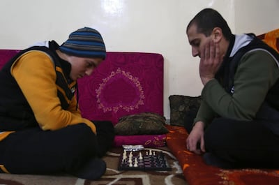 Mohammed Haj Ahmad (R), 23, plays chess with his roommate at the Syrian Centre for Countering Extremist Ideology on November 30, 2017. Nazeer Al Khatib / AFP