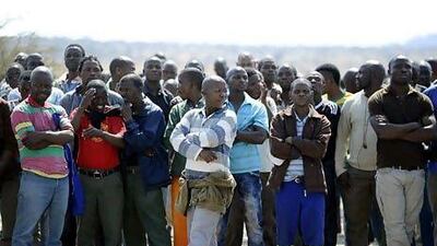 Striking platinium miners gather at London-listed Lonmin's Marikana platinum mine, where police opened fire on hundreds of workers staging a wildcat strike.
