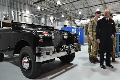 Prince Philip with a 1960s ceremonial Land Rover once owned by the The Queen Mother, during a visit the Prince Philip Barracks at MOD Lyneham, England, in 2016. Getty Images