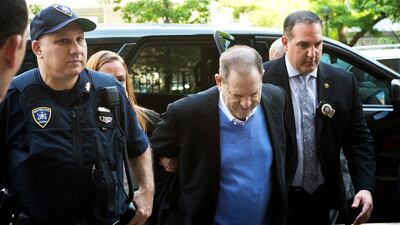 Harvey Weinstein is escorted into court in New York. Weinstein surrendered Friday to face rape and other charges from encounters with two women. Mark Lennihan/ AP Photo