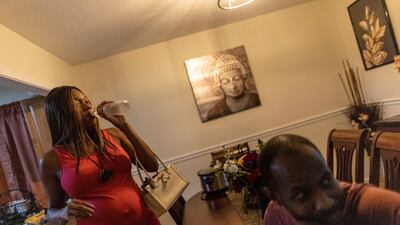 Ashley Tose, who is seven months pregnant, drinks from a bottle of water in Jackson. Reuters