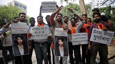 Activists of ultra right-wing Hindu Sena or Hindu Army hold posters featuring photographs of Indian actress Priyanka Chopra during a protest in New Delhi, India. AP photo