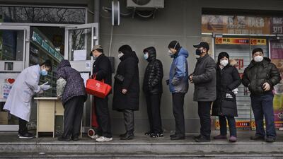 Chinese residents line up to get a free protective mask at a local pharmacy in Beijing, China. Getty Images