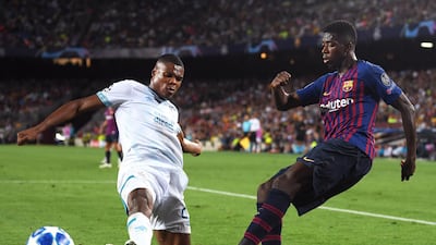 Barcelona's Ousmane Dembele crosses the ball under pressure from PSV Eindhoven's Denzel Dumfries. Getty Images
