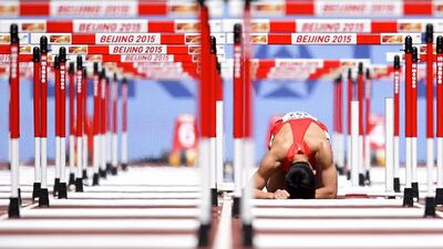 China’s Zhang Honglin reacts after falling during the men’s 110 metres hurdles athletics event at the 2015 IAAF World Championships at the Bird’s Nest National Stadium in Beijing. Olivier Morin / AFP