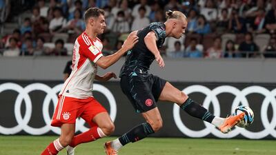 Manchester City's Erling Haaland and Bayern Munich defender Josip Stanisic battle for the ball. AFP