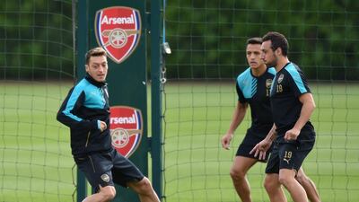 Arsenal's Mesut Ozil trains with teammates Alexis Sanchez, centre, and Santi Cazorla, right, on Monday for their Champions League contest on Tuesday. Olly Greenwood / AFP