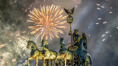 Fireworks light the sky above the Quadriga at the Brandenburg Gate during New Year's celebrations shortly after midnight in Berlin, Germany. AP