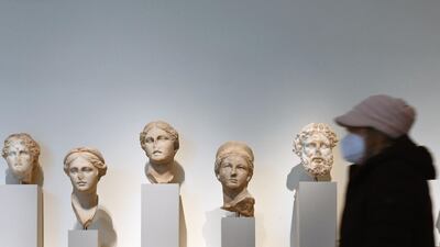 A visitor walks past stone sculptures at The Metropolitan Museum of Art, in New York City. AFP