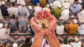 A Muslim man holds tabarrukat (blessed offerings) during prayers at the Hazratbal Shrine in Srinagar, Indian Kashmir. EPA