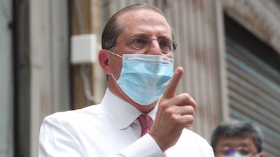 US Secretary of Health and Human Services Alex Azar gestures while visiting a mask factory in the Wugu district of New Taipei City on August 12, 2020. Azar is in Taipei for a three-day visit. / AFP / POOL / Pei Chen