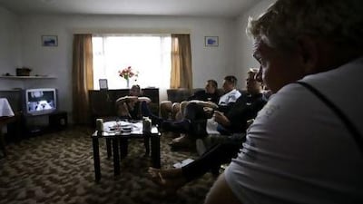 Tony Mutter and crew watching TV in the team's Tristan da Cunha housing.