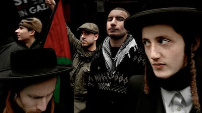 UK. London. 2011. Muslims, alongwith members of Neturei-Karta, an organization of Orthodox Jews, protest outside the Israeli Embassy to mark the third anniversary of Israel's attack on Gaza. Members of Neturei-Karta refuse to recognize the existence or authority of the ‘State of Israel’ and make a point of publicly demonstrating their position, the position of the Torah and authentic unadulterated Judaism.