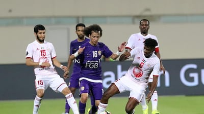 Al Ain's Mohammed Abdulrahman, centre, bursts through the Sharjah defence. Courtesy Aletihad