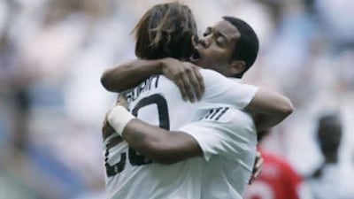 Real Madrid's Gonzalo Higuain, left, celebrates with teammate Marcelo Vieira.