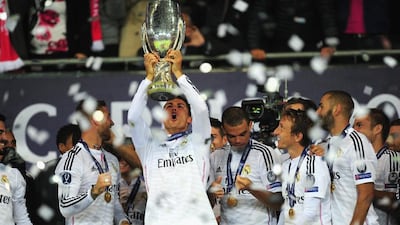 Real Madrid player Ronaldo lifts the trophy after the UEFA Super Cup match between Real Madrid and Sevilla FC at Cardiff City Stadium on August 12, 2014 in Cardiff, Wales. (Photo by Stu Forster/Getty Images)