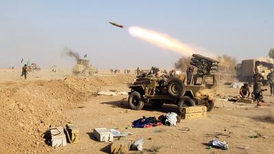 Hashed Al Shaabi fighters launch missiles on the village of Salmani, south of Mosul, on October 30, 2016. AFP