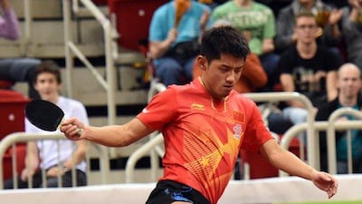 Zhang Jike stomps an advertising board in celebration after winning the Table Tennis World Cup final match in Dusseldorf, Germany on Sunday. Henning Kaiser / EPA / October 26, 2014