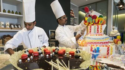 The Hilton’s award winning executive pastry chef, Praveen Kumar, right, and his team have created a replica model of the Grand Mosque to mark the holy month of Ramadan. Mona Al Marzooqi / The National