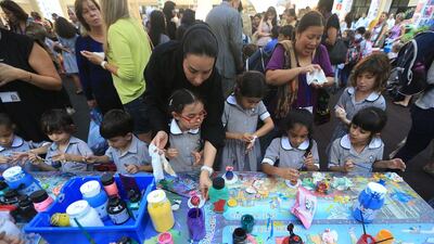 Students doing pottery painting at Pearl Primary School during a art exhibition in Abu Dhabi. Ravindranath K / The National