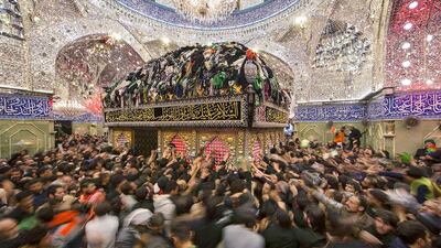 Shiite pilgrims reach out to touch the tomb of Imam Al Abbas located inside the Imam Al Abbas shrine in the holy city of Kerbala on December 13. Reuters