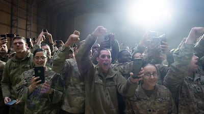 Members of the US military cheer as US President Donald Trump arrives to speak during an unannounced trip to Al Asad Air Base in Iraq. AFP