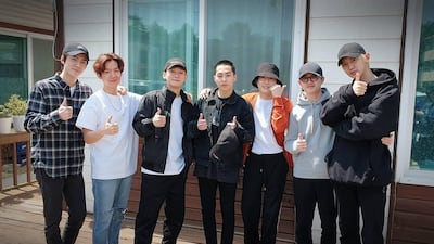 Members of Exo pose together before Xiumin departs for his mandatory military service.