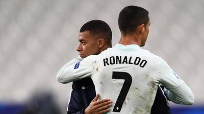 Portugal's forward Cristiano Ronaldo, right, embraces France forward Kylian Mbappe at the end of the match. AFP
