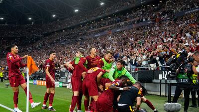 Paulo Dybala is mobbed by Roma teammates after scoring their first goal. AP P