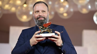 Yorgos Lanthimos holds the Golden Lion award for his film Poor Things at the closing ceremony. EPA