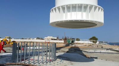 One of the 120-metre flagpoles being lowered into position.