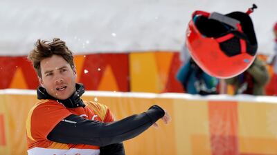 Bronze medal winner Zan Kosir, of Slovenia, tosses his helmet after the men's parallel giant slalom small final at Phoenix Snow Park at the 2018 Winter Olympics in Pyeongchang, South Korea. Kin Cheung / AP Photo