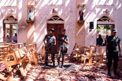 Sri Lankan soldiers look on inside the St Sebastian's Church at Katuwapitiya in Negombo following a bomb blast during the Easter service. AFP