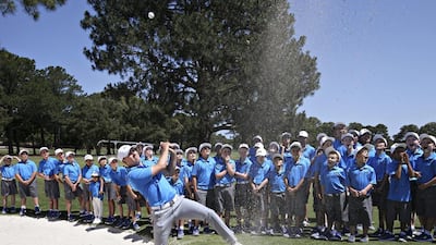 American golfer Jordan Spieth hits the ball over his head during a clinic for young golfers at the Australian Golf Club in Sydney. Rick Rycroft / AP Photo