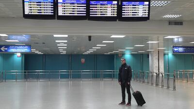 A tourist looks at the arrivals bulletin board. AFP