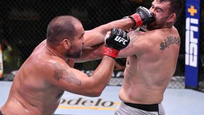 Blagoy Ivanov of Bulgaria (red gloves) punches Augusto Sakai of Brazil (blue gloves) in their heavyweight fight during UFC Fight Night. Zuffa