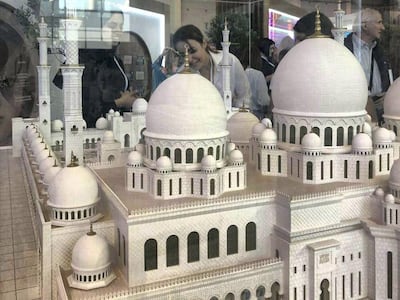 People look at the replica model of the Sheikh Zayed Grand Mosque model in Moscow. Balquees Basalom / The National
