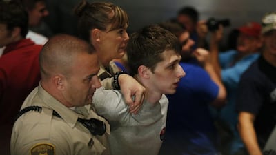 Police remove Michael Sandford after he tried to take a police officer’s gun and kill Donald Trump during a weekend rally in Las Vegas. John Locher / AP Photo