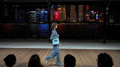 A model presents a creation for Kenzo by Japanese fashion designer Tomoaki Nagao aka Nigo during Kenzo fashion show at the North Bund Bay in Shanghai on July 28, 2023. (Photo by Jade GAO / AFP)