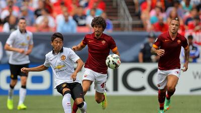 Shinji Kagawa, left, of Manchester United makes a pass as Salih Ucan, right, of AS Roma defends during their match on Saturday in America in the International Champions Cup pre-season tournament. Justin Edmonds / Getty Images / AFP