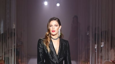 A smart black suit seen on a model.